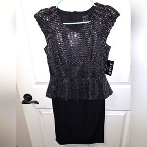 An Alexa B Nites sleeveless black sequined Midi dress in a size 6. NWT.